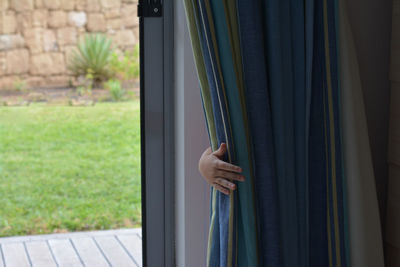 Child hiding behind curtain