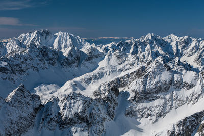 Scenic view of snowcapped mountains against sky. view from lomnica, tatra mountains, poland