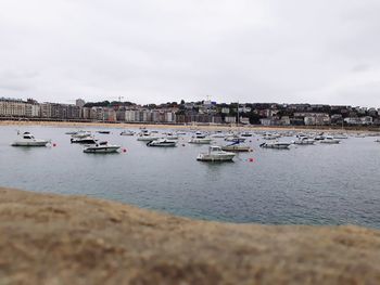 Boats moored in sea against sky