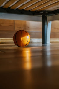 A children's basketball under the bed in the sun.