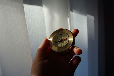 Close-up of hand holding clock