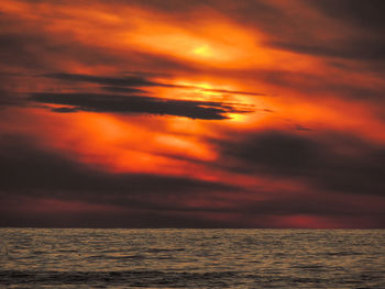 Scenic view of sea against romantic sky at sunset