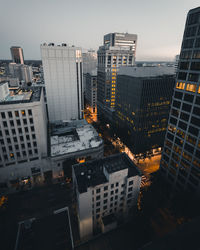 High angle view of illuminated buildings against sky at dusk