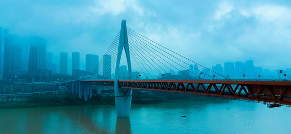 View of bridge over river in city