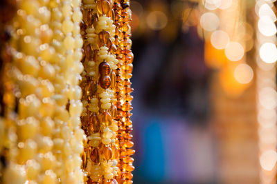 Close-up of illuminated lanterns hanging at market stall