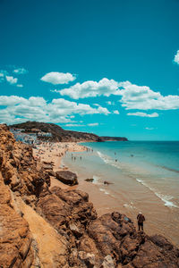 Scenic view of beach with blue sky in algarve