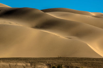 Scenic view of desert against clear sky