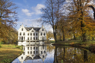 Reflection of trees and buildings in lake