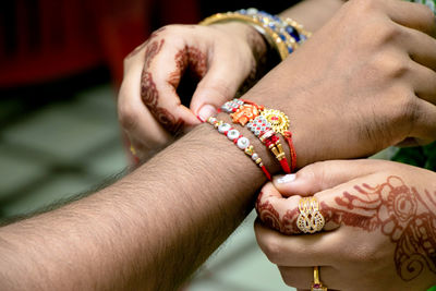 Midsection of woman holding hands