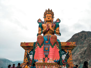 Statue in temple against sky