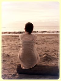 Rear view of woman standing on beach