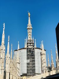 Low angle view of buildings against blue sky