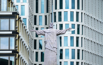 Christ the redeemer statue against buildings