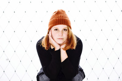 Portrait of beautiful young woman in knit hat