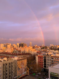 High angle view of rainbow over buildings in city