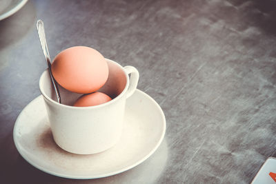 Close-up of eggs in cup on table