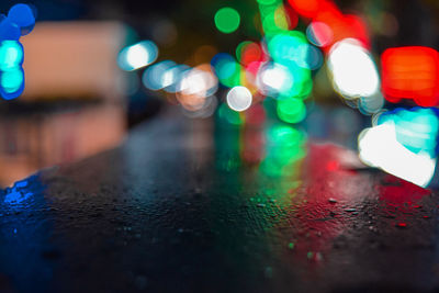 Defocused image of illuminated lights on table