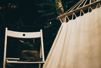 Empty chair by hammock