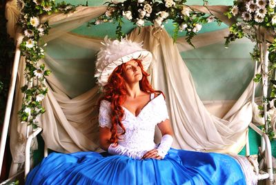 Bride sitting on decorated swing