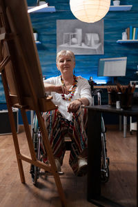 Portrait of young woman sitting on chair