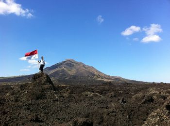 Low angle view of man on mountain against sky