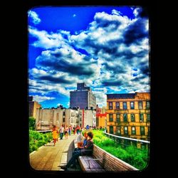 City buildings against cloudy sky