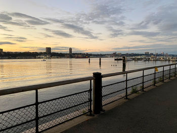 Bridge over river against sky during sunset