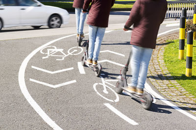 Low section of person riding bicycle on road