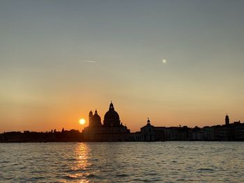 Silhouette of building against sky during sunset