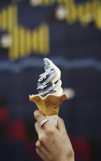 Close-up of hand holding ice cream cone