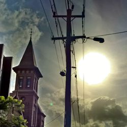 Low angle view of power lines against cloudy sky