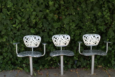 Seats against plants at park