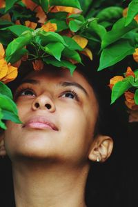 Close-up of teenage girl by plants