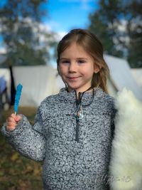 Portrait of smiling girl holding snow