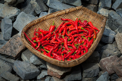 High angle view of red chili peppers in basket