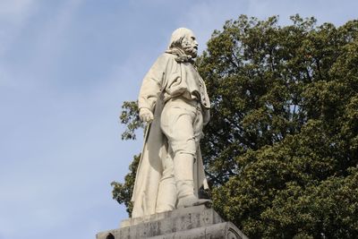 Low angle view of statue against sky