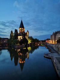 Reflection of illuminated buildings in calm river at night