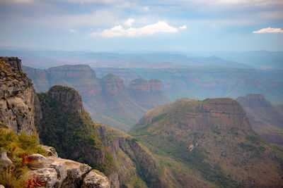 Scenic view of mountains against cloudy sky