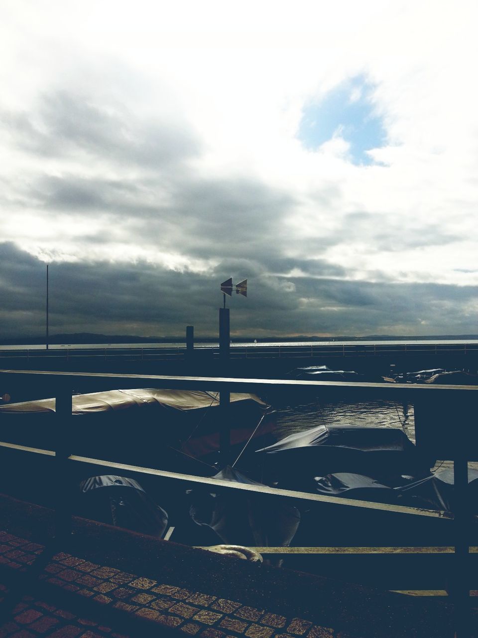 sky, cloud - sky, sea, cloudy, built structure, railing, water, architecture, cloud, horizon over water, weather, tranquility, silhouette, nature, tranquil scene, scenics, building exterior, overcast