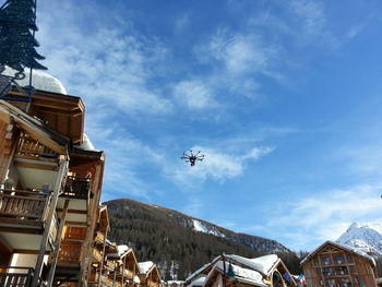 Low angle view of drone flying over village