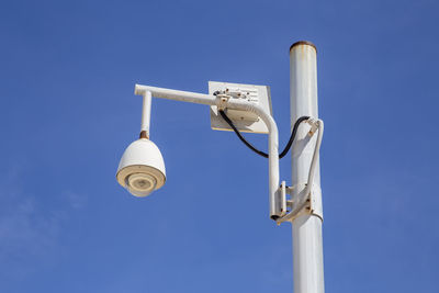 Low angle view of street light against blue sky