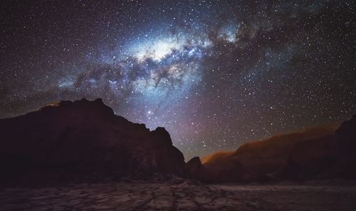 Scenic view of mountains against star field