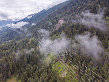 Scenic view of trees and mountains against sky