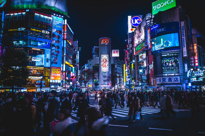 Crowd at illuminated city at night