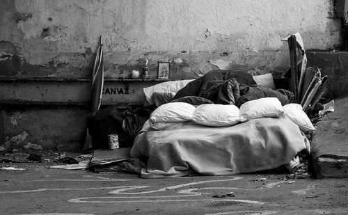 Abandoned bed and pillows on street
