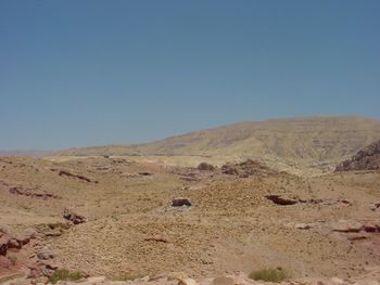 Scenic view of desert against clear blue sky