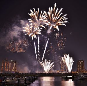 Firework display over city at night