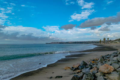 Scenic view of beach against blue sky