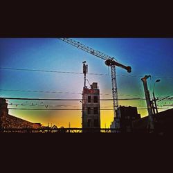 Low angle view of electricity pylon against sky