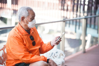 Side view of man using mobile phone